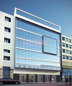 a large glass building with people walking in front of it at In the heart of Lima in Lima