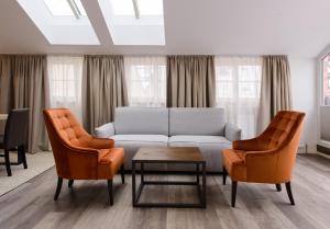 a living room filled with furniture and a window at Kaiser Max Design Appartements in Innsbruck
