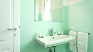 a bathroom with a white sink and a mirror at Sardegna é - Villa Charme&Design in Olbia +33 photos