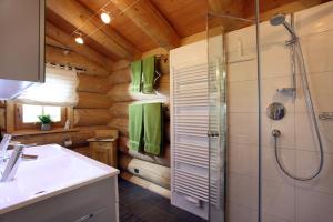 ein Badezimmer mit Dusche und Waschbecken in der Unterkunft Blockhaus Chalet Heim in Kirchberg in Tirol