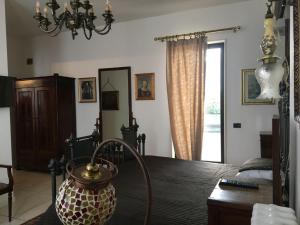 a room with a bed and a table with a lamp at Palace B&B in Acquaviva delle Fonti