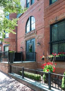 a brick building with flowers in front of it at Inn at St. Botolph in Boston