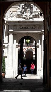 three children walking through an archway in a building at Trentapassidairolli in Genova