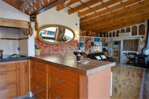 a kitchen with a counter with a mirror and wine glasses at Casa del Beso in Granada