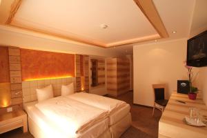 Postel nebo postele na pokoji v ubytování Hotel Garni Muttler Alpinresort & Spa