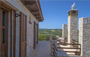 a porch of a house with a bench and a view at Grecian Villas Chania in Delimanolianá