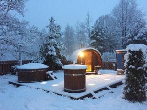 a gazebo in a yard covered in snow at Wypoczynek na Mazurach U Sebka in Łukta