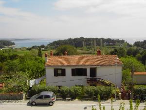 a house with a car parked in front of it at Dunja Residence in Premantura