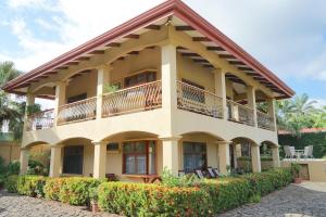 a large building with a balcony on top of it at Villas Welcome to Heaven in Carrillo