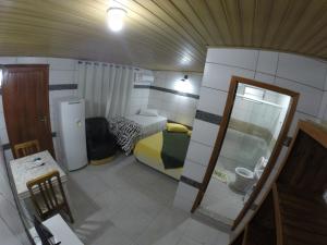 a small room with a bed and a bathroom at Morada Manga Rosa Pousada in Florianópolis +124 photos