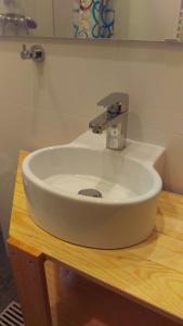 a white sink sitting on top of a wooden table at Köln Deutz/Messe, Lanxess Arena in Cologne