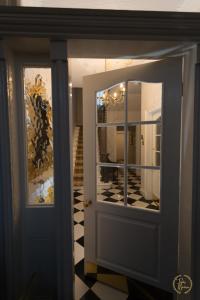 a door leading to a room with a mirror at Trinity Boutique B&B in Peterhead