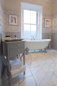 a large bathroom with a tub and a window at Trinity Boutique B&B in Peterhead +55 photos