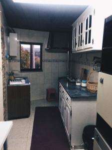 a kitchen with white cabinets and a black counter top at Casa Urgueira in Pendilhe +13 photos