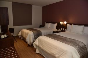 Voodi või voodid majutusasutuse Lithio Hotel toas