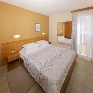 Postel nebo postele na pokoji v ubytování Apartments Stella Plava Laguna