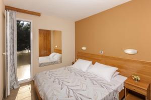 Postel nebo postele na pokoji v ubytování Apartments Stella Plava Laguna