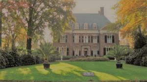 a large house with a lawn in front of it at Boutiquehotel Sycamore - Protected City View - 950m from Central Station in Eindhoven
