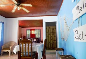 a dining room with a table and a ceiling fan at Fairmont in Negril
