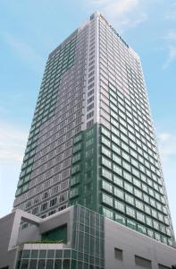a tall building with a lot of windows at Hotel COZi Harbour View in Hong Kong