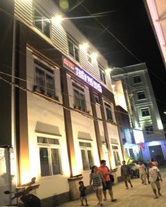 a group of people walking in front of a building at Thien Phu Nghia 2 - Hotel Phu Quoc in Phú Quốc