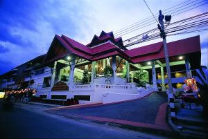 a large building with purple roofs on a street at BP Chiangmai City Hotel in Chiang Mai