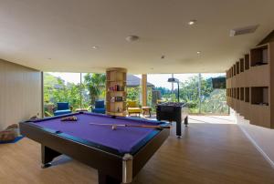 a billiard room with a pool table in a house at Mandarava Resort and Spa, Karon Beach - SHA Extra Plus in Karon Beach