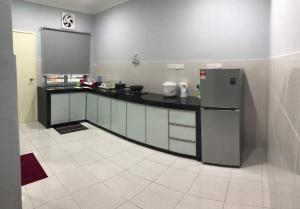 a kitchen with a counter and a refrigerator at ARA Muslim House @ Mutiara Heights Johor Bahru in Johor Bahru