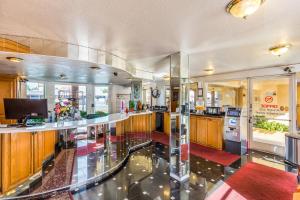 a large kitchen with a counter and a stove at Colonial Pool & Spa Motel in Long Beach