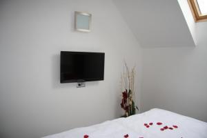 a bedroom with a tv on a white wall at Art Hotel Podebrady in Poděbrady