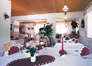 a room with a white table with flowers on it at Hotel Landgut Ochsenkopf in Rotta