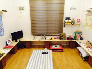 a room with a desk with a computer and a window at Geoje Ton Ton Guesthouse in Geoje