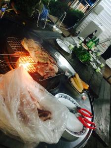 a grill with a bunch of food on a table at Geoje Ton Ton Guesthouse in Geoje 
