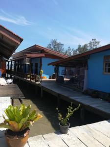a house on the water with plants on a dock at Chomlay Room & Restaurant in Ko Lanta +7 photos