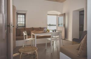 a kitchen and living room with a table and chairs at Donusa Beach House - Etheras properties in Diakofti