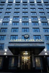 a building with a sign that reads garden park inn at Garden Park Inn in Almaty