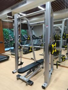 a gym with treadmills and elliptical machines at Rongjiang Hotel in Jieyang