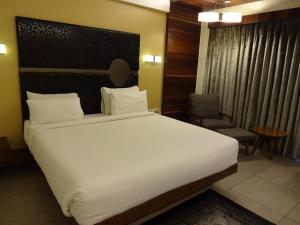 Postel nebo postele na pokoji v ubytování Hotel Cosmopolitan