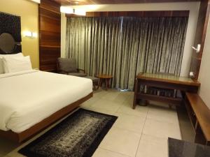 Postel nebo postele na pokoji v ubytování Hotel Cosmopolitan