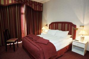 a hotel room with a large bed and a chair at Addar Hotel in Jerusalem