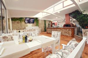 une salle à manger avec une table et des chaises blanches dans l'établissement Hotel Palas, à Kazanlak