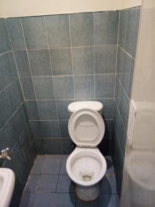 a bathroom with a toilet and a sink at Anthurium Inn in Mactan