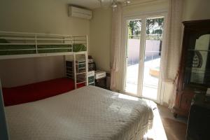 a bedroom with a bunk bed and a window at villa avec jacuzzi in Sainte-Maxime +11 photos