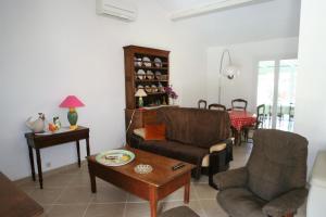 a living room with two chairs and a table at villa avec jacuzzi in Sainte-Maxime