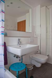 a bathroom with a sink and a toilet and a mirror at Haus Josefine in Friedrichshafen +19 photos
