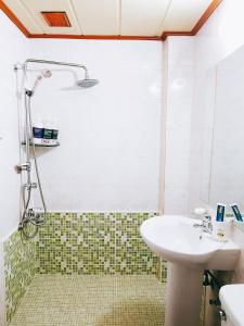 ein Bad mit einem Waschbecken und einer Dusche in der Unterkunft Gumi A Motel in Gumi