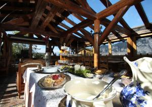 a table with a plate of food on it at Alp Art Hotel Götzens in Innsbruck