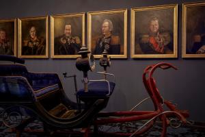 a painting of a man riding a horse drawn carriage at 25hours Hotel The Royal Bavarian in Munich