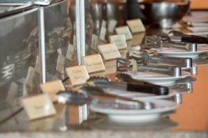 a display case with plates and utensils on a table at Pinnacle Samui Resort in Mae Nam