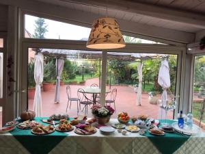 a table with plates of food on it in a house at Villa Cristina in Siracusa